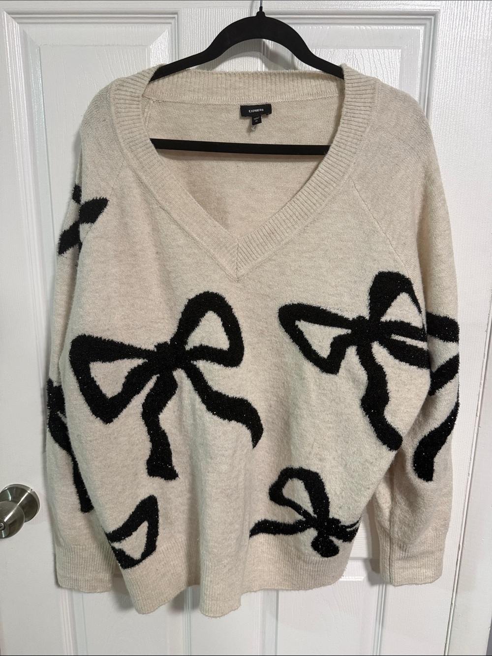 Express Cream V-Neck Sweater with Black Bow Accents